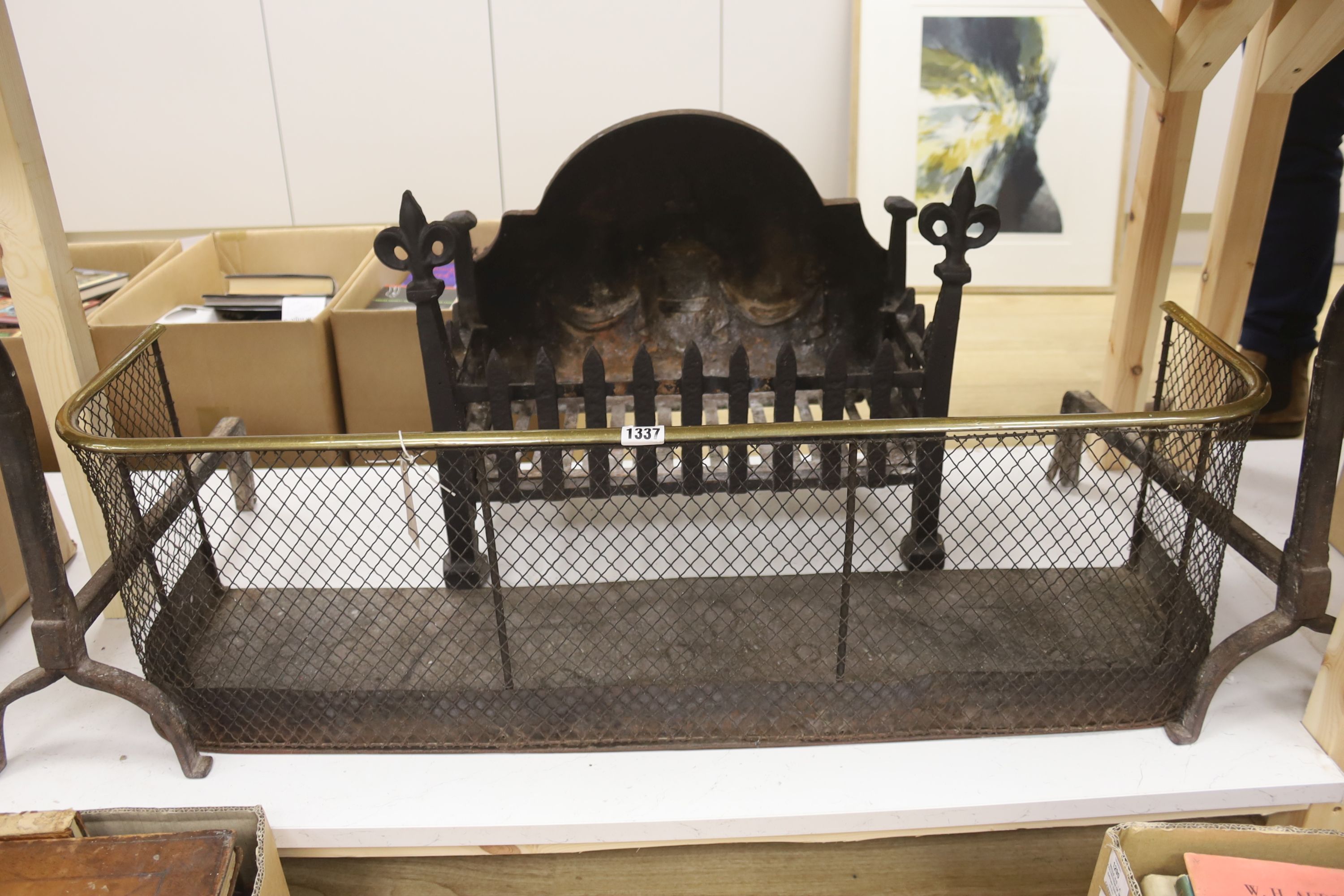 A wrought iron fire grate, a pair of fire dogs and a Regency brass tipped wire mesh fire guard, length 97cm